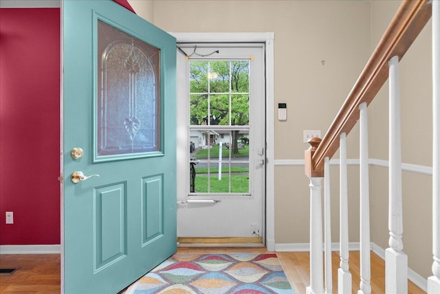 2020 NW Ave, Lansing, MI 48906 - foyer entrance featuring stairway, wood finished floors, and baseboards