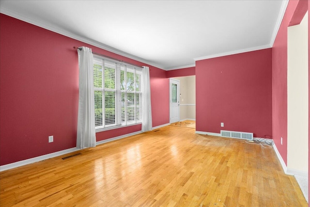 2020 NW Ave, Lansing, MI 48906 - empty room with wood finished floors, baseboards, and crown molding