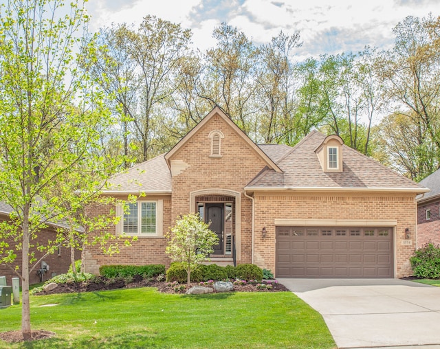 5514 Woodfall Rd, Clarkston, MI 48348 - view of front of property featuring a garage, driveway, brick siding, a shingled roof, and a front yard