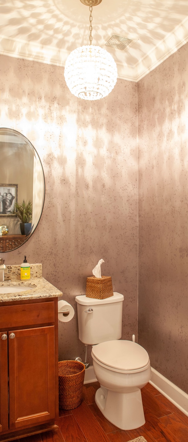 5514 Woodfall Rd, Clarkston, MI 48348 - half bathroom with toilet, wood finished floors, vanity, and baseboards