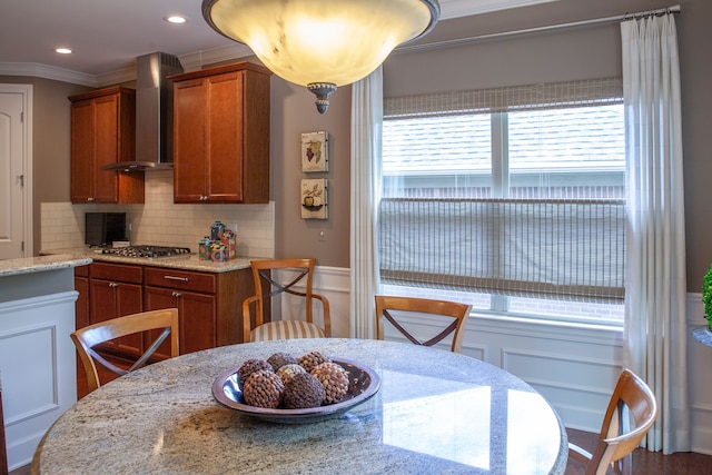 5514 Woodfall Rd, Clarkston, MI 48348 - kitchen with wall chimney range hood, crown molding, decorative backsplash, brown cabinets, and stainless steel gas cooktop