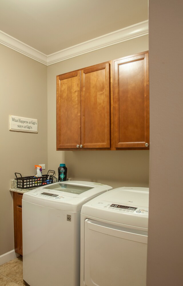 5514 Woodfall Rd, Clarkston, MI 48348 - laundry area featuring cabinet space, washer and dryer, crown molding, and baseboards