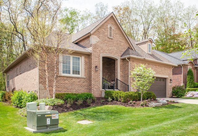 5514 Woodfall Rd, Clarkston, MI 48348 - view of front facade with brick siding, a garage, a front yard, and driveway