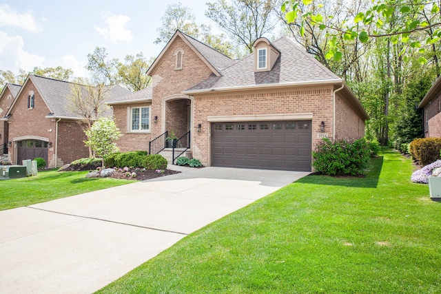 5514 Woodfall Rd, Clarkston, MI 48348 - view of front facade featuring brick siding, an attached garage, concrete driveway, and a front lawn