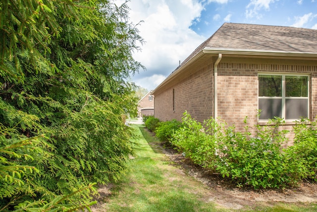 5514 Woodfall Rd, Clarkston, MI 48348 - view of property exterior featuring brick siding and roof with shingles