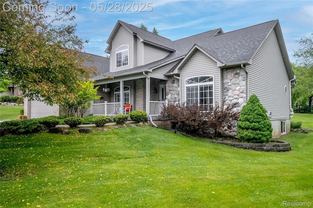 105 Crescent Hill Dr, Ortonville, MI 48462 - traditional-style house with covered porch, a front lawn, roof with shingles, stone siding, and a garage