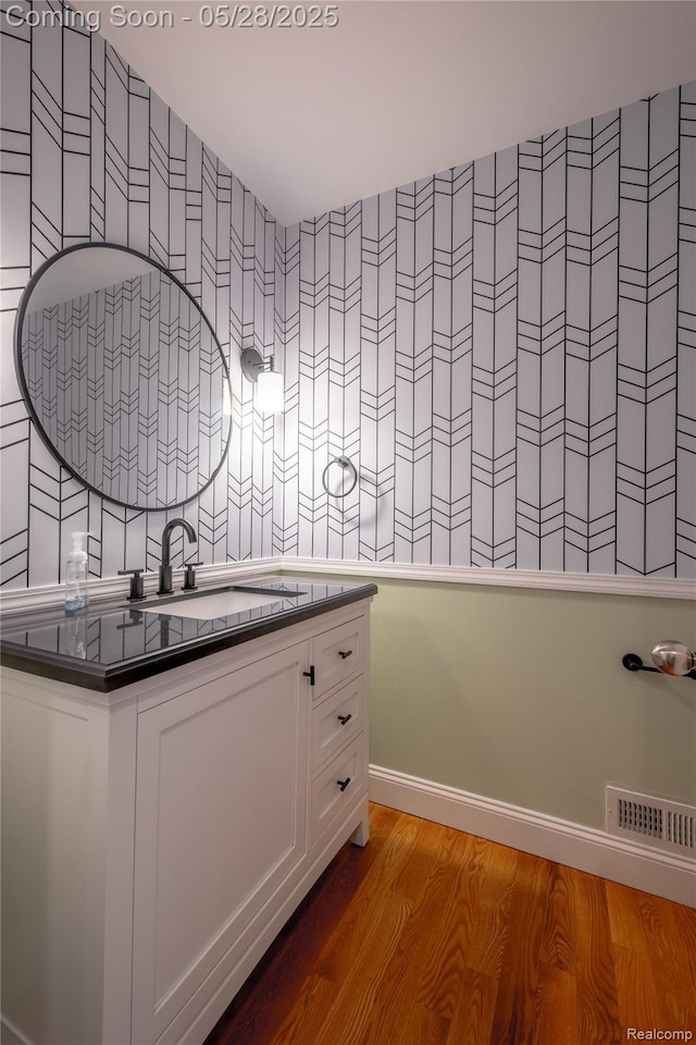 105 Crescent Hill Dr, Ortonville, MI 48462 - bathroom featuring wood finished floors, vanity, and wallpapered walls