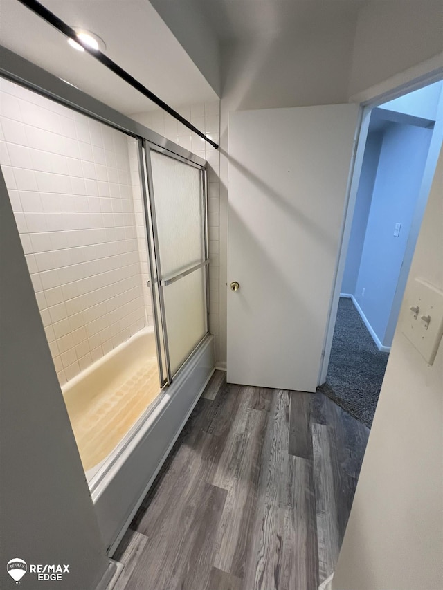 1132 Wisner St, Mount Morris, MI 48458 - full bathroom featuring a shower with shower door and wood finished floors