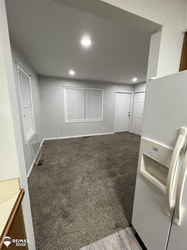 1132 Wisner St, Mount Morris, MI 48458 - basement featuring white fridge with ice dispenser, recessed lighting, and carpet floors