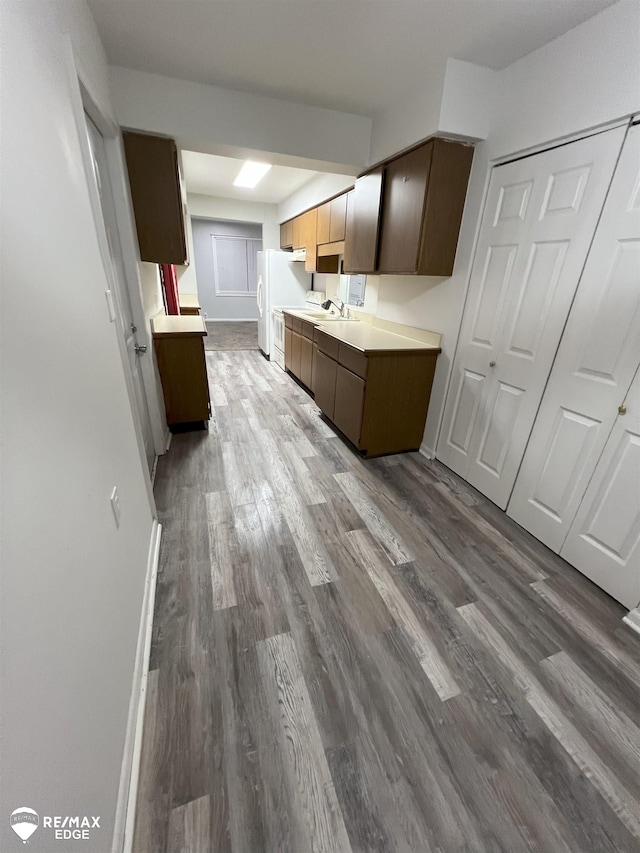 1132 Wisner St, Mount Morris, MI 48458 - kitchen with dark wood finished floors, freestanding refrigerator, and light countertops