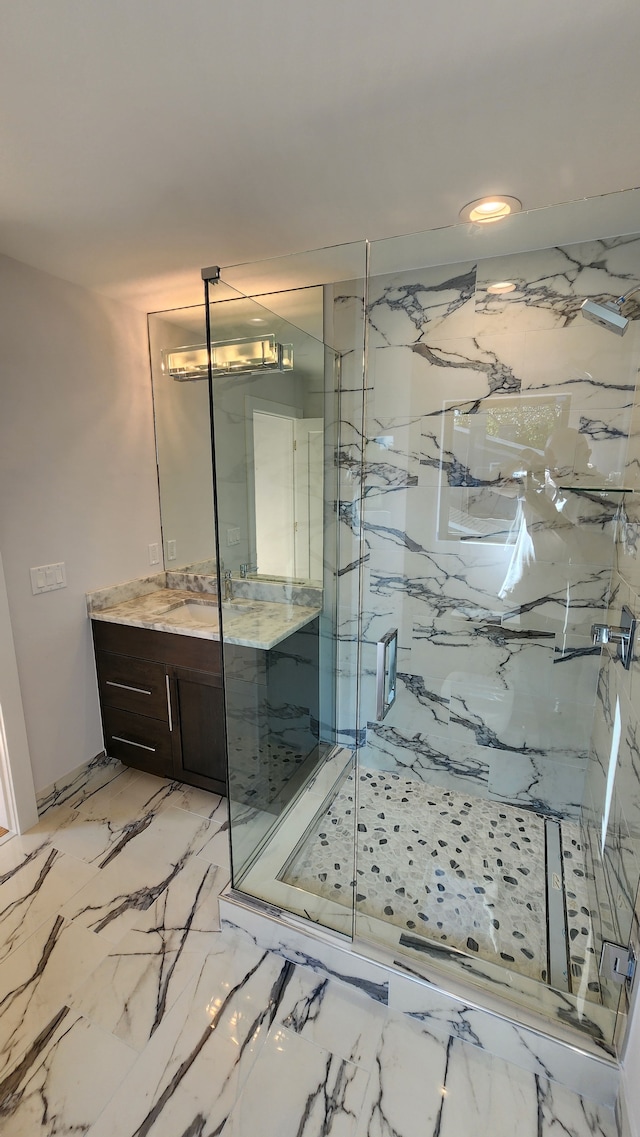 full bath featuring vanity, a marble finish shower, marble finish flooring, and recessed lighting