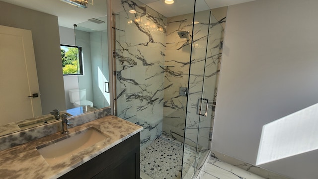 bathroom featuring a marble finish shower, marble finish flooring, toilet, and vanity