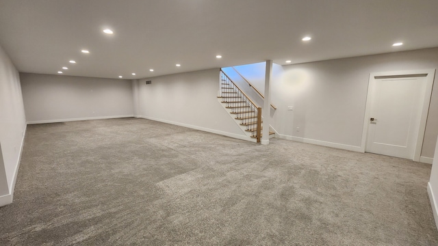 finished below grade area featuring recessed lighting, carpet flooring, stairs, and baseboards