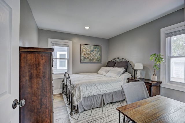 bedroom with light wood-style flooring, multiple windows, recessed lighting, and baseboards