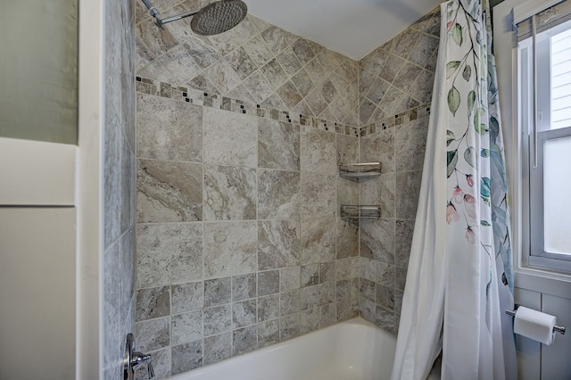 bathroom featuring shower / bath combination with curtain and healthy amount of natural light