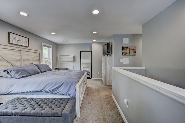 bedroom with recessed lighting, light colored carpet, baseboards, and a wall mounted AC