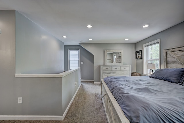carpeted bedroom with baseboards, multiple windows, and recessed lighting