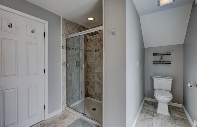 full bathroom with baseboards, a shower stall, and toilet