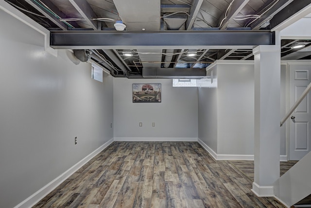 below grade area with wood finished floors and baseboards