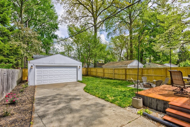 view of yard with an outdoor fire pit, an outdoor structure, a garage, and a wooden deck