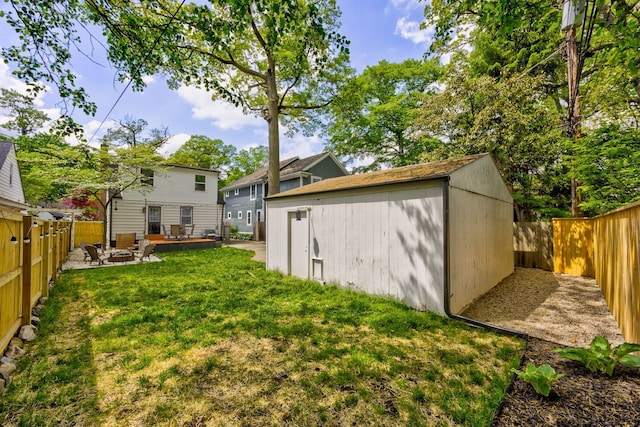view of yard featuring an outdoor structure and a patio area