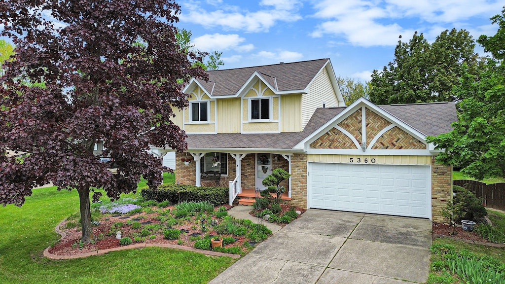 5360 Old Franklin Ct, Grand Blanc, MI 48439 - view of front of home featuring covered porch, driveway, a garage, a front lawn, and brick siding