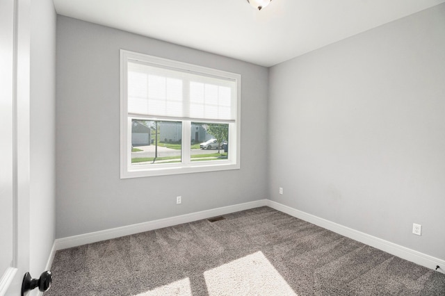 carpeted spare room with baseboards