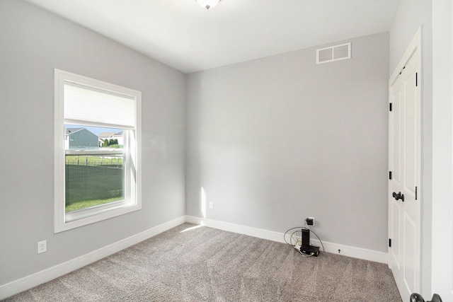 carpeted spare room with baseboards