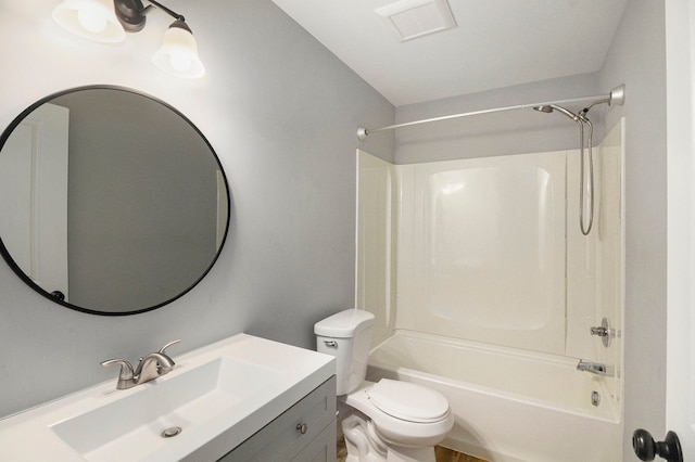 full bathroom with toilet, vanity, and washtub / shower combination