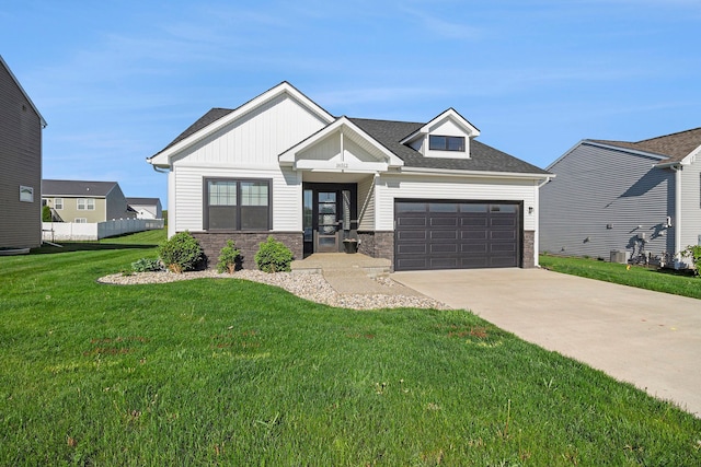 modern farmhouse with driveway, an attached garage, a front lawn, and stone siding