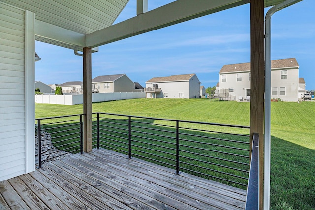 wooden deck with a residential view and a lawn