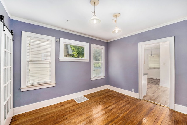 22619 Santa Maria St, Detroit, MI 48219 - unfurnished room with hardwood / wood-style floors, crown molding, baseboards, and a barn door