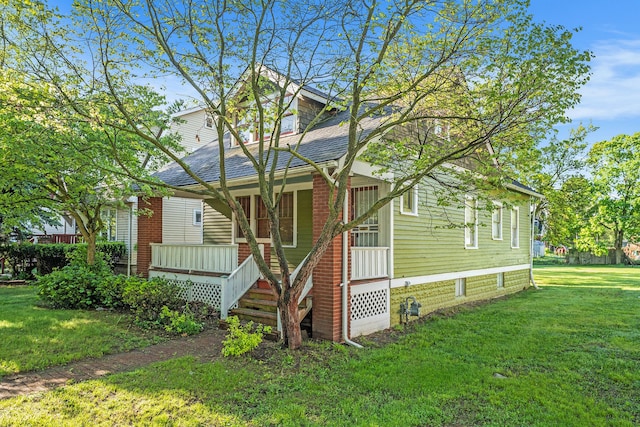 22619 Santa Maria St, Detroit, MI 48219 - bungalow featuring a front yard, a shingled roof, and covered porch