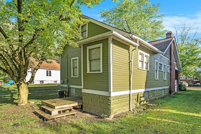 22619 Santa Maria St, Detroit, MI 48219 - view of home's exterior with a chimney and a lawn