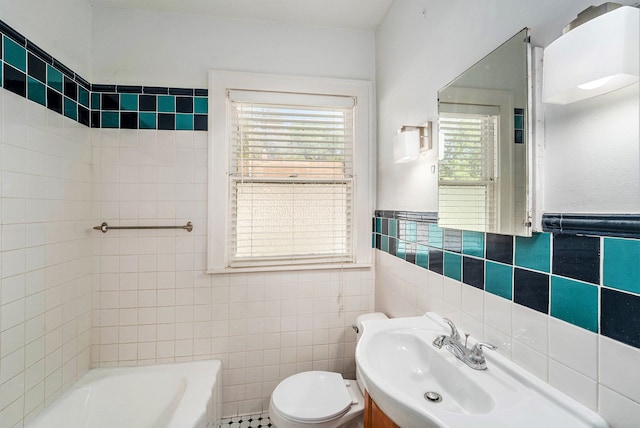 22619 Santa Maria St, Detroit, MI 48219 - bathroom with tile walls, a tub to relax in, toilet, a sink, and a wainscoted wall
