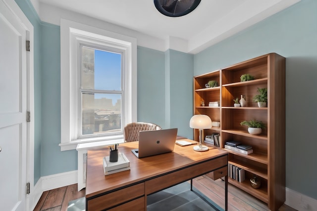 office space with wood finished floors and baseboards