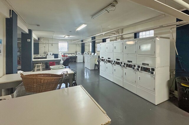 garage with stacked washing machine and dryer and separate washer and dryer
