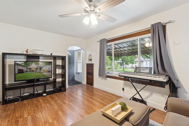 1430 New York Ave, Lansing, MI 48906 - living area with arched walkways, wood finished floors, baseboards, and a ceiling fan