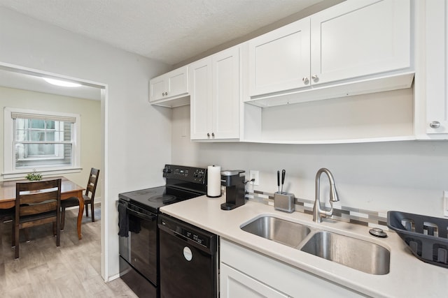 1430 New York Ave, Lansing, MI 48906 - kitchen featuring black appliances, a sink, open shelves, white cabinets, and light countertops