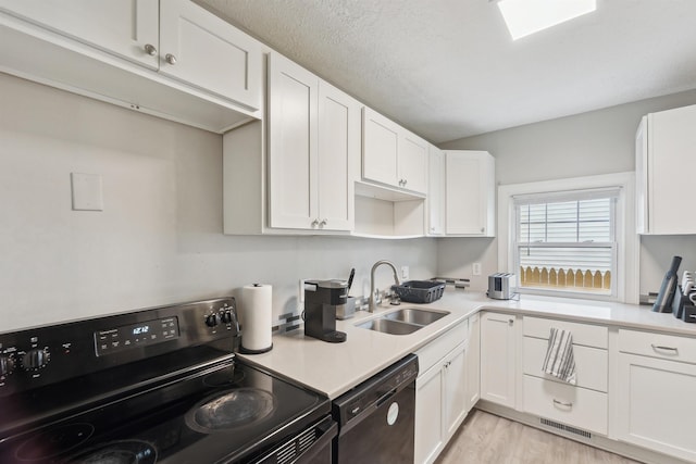 1430 New York Ave, Lansing, MI 48906 - kitchen featuring electric range, dishwashing machine, a sink, and white cabinets