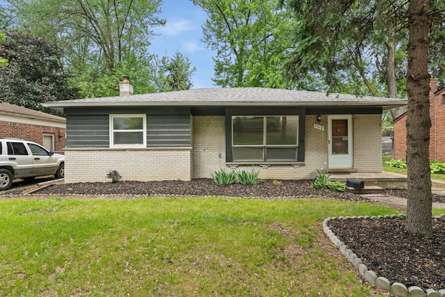 9319 Merriman Rd, Livonia, MI 48150 - view of front facade featuring brick siding, a front lawn, and a chimney