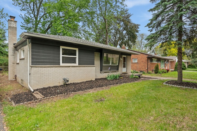 9319 Merriman Rd, Livonia, MI 48150 - ranch-style home featuring a chimney, brick siding, and a front yard