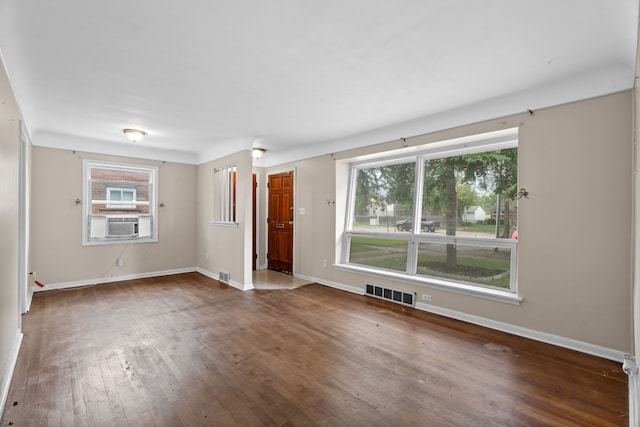 9319 Merriman Rd, Livonia, MI 48150 - unfurnished room featuring wood-type flooring, baseboards, and cooling unit