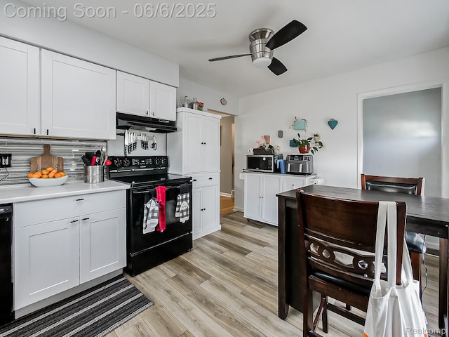13327 Murthum Ave, Warren, MI 48088 - kitchen featuring black appliances, under cabinet range hood, a ceiling fan, light wood-type flooring, and white cabinets