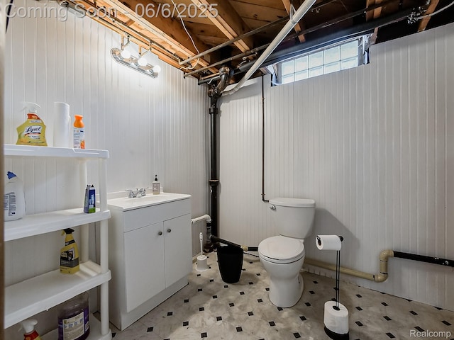 13327 Murthum Ave, Warren, MI 48088 - bathroom with tile patterned floors, toilet, vanity, and wood walls