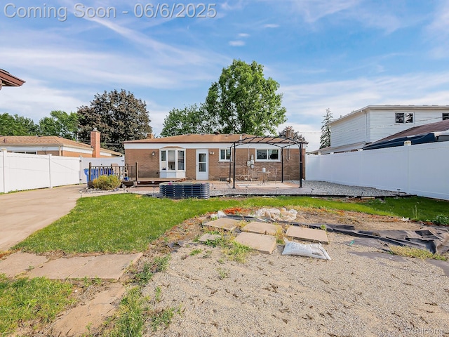 13327 Murthum Ave, Warren, MI 48088 - rear view of house featuring a wooden deck, a fenced backyard, brick siding, a pergola, and a patio area