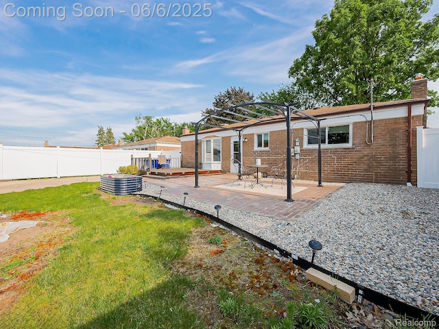 13327 Murthum Ave, Warren, MI 48088 - rear view of house featuring a chimney, a pergola, brick siding, and a patio area
