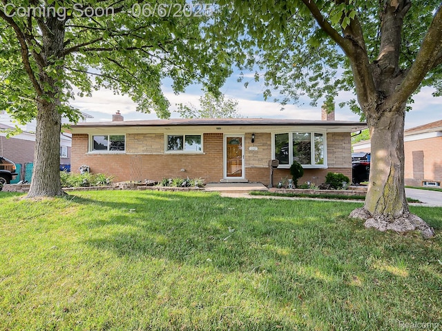13327 Murthum Ave, Warren, MI 48088 - single story home with a chimney, a front lawn, and brick siding