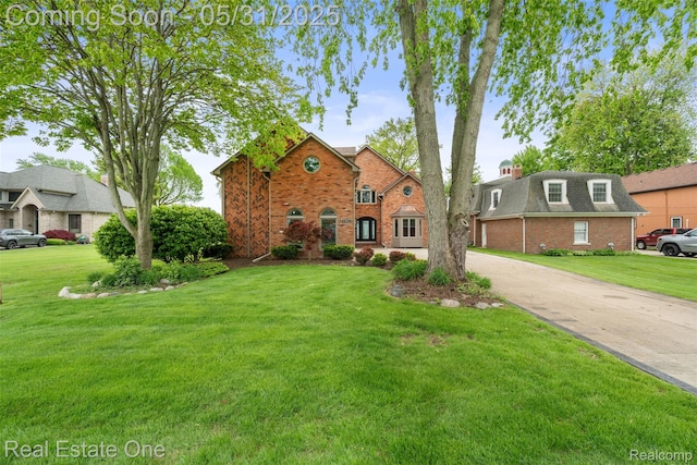 48556 Harbor Dr, Chesterfield, MI 48047 - view of front of home with brick siding, a front yard, and driveway