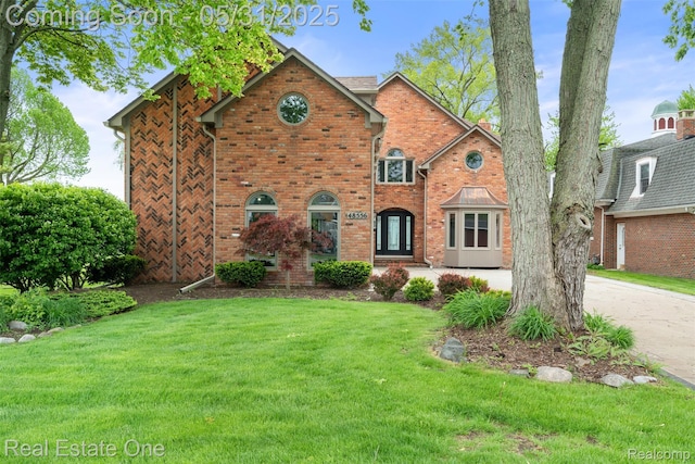 48556 Harbor Dr, Chesterfield, MI 48047 - tudor house featuring a front yard and brick siding